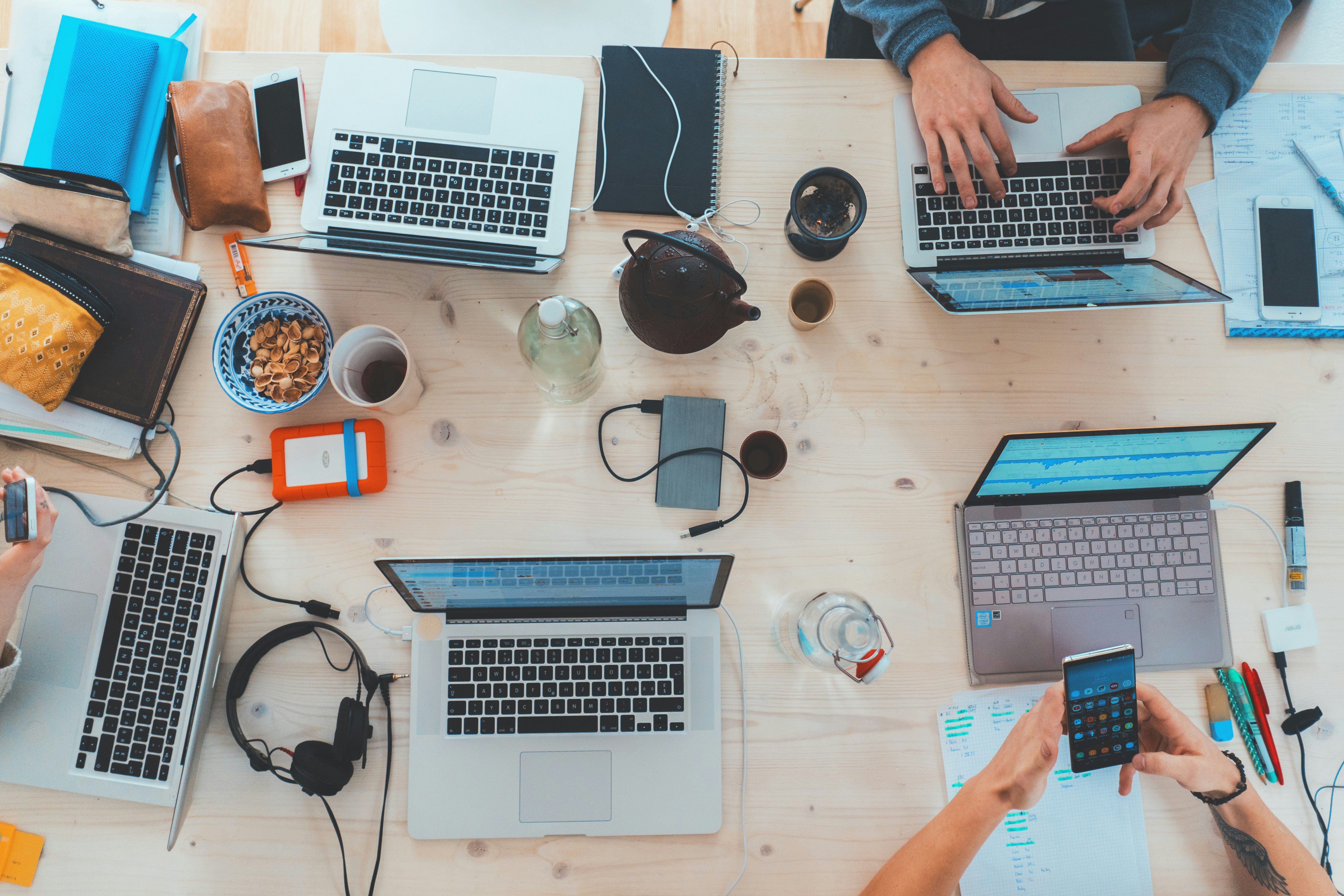 Five laptops open on a desk.